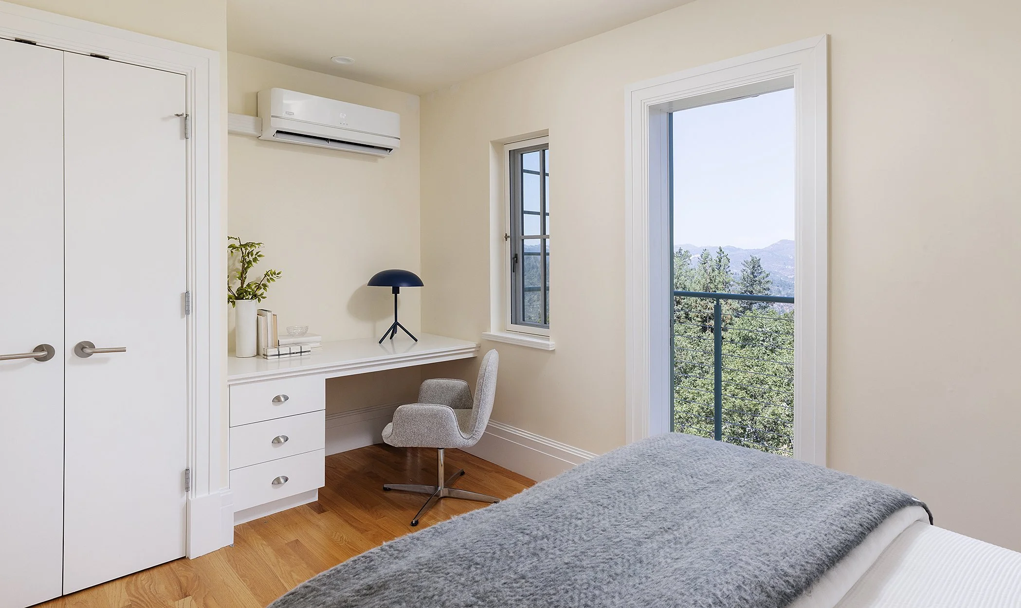 Bedroom desk and balcony door with mountain view